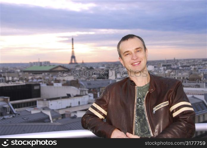 Portrait of a man on background of Paris view