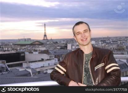 Portrait of a man on background of Paris view