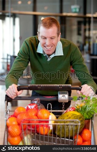 Portrait of a man pushing a grocery cart in a grocery store