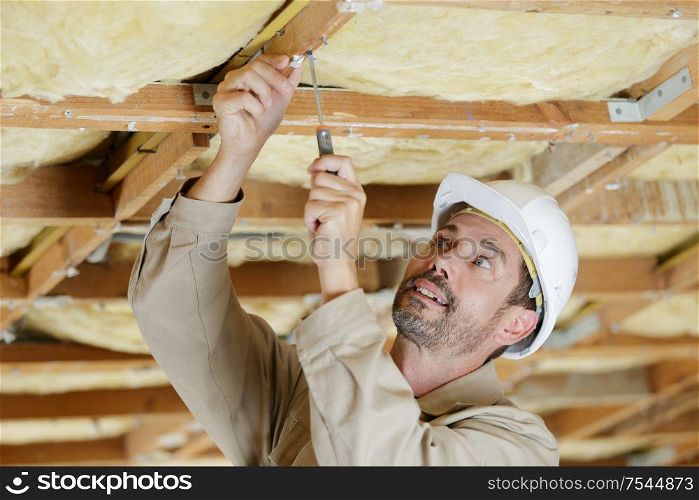 portrait of a man screwing with a screwdriver