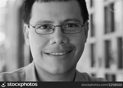 Portrait of a man smiling wearing eyeglasses, black and white