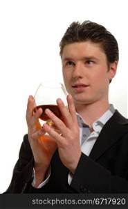 Portrait of a man with a glass of cognac on the white background