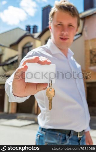 portrait of a man with a key of new house focus on the key