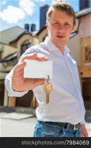 portrait of a man with a key of new house focus on the key