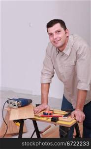 portrait of a man with electric saw
