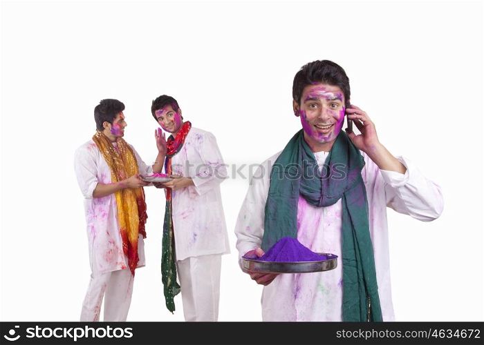 Portrait of a man with holi colour talking on a mobile phone