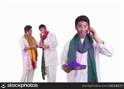 Portrait of a man with holi colour talking on a mobile phone