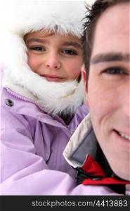 Portrait of a man with little girl by wintertime