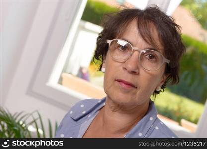 Portrait of a mature brunette woman with eyeglasses