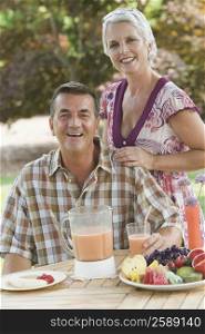 Portrait of a mature couple at a breakfast table and smiling