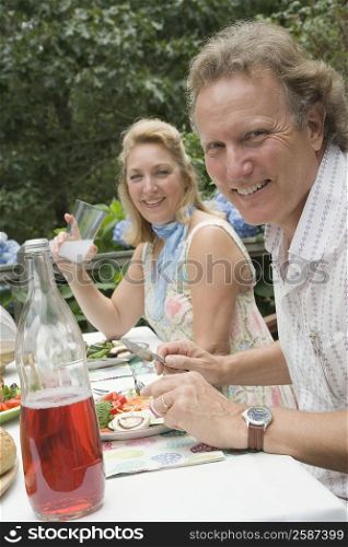 Portrait of a mature couple having breakfast and smiling