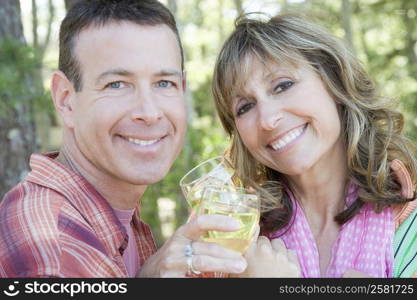 Portrait of a mature couple holding glasses of wine and smiling