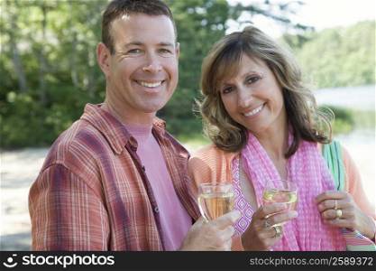 Portrait of a mature couple holding glasses of wine and smiling