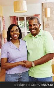 Portrait of a mature couple holding hands and smiling