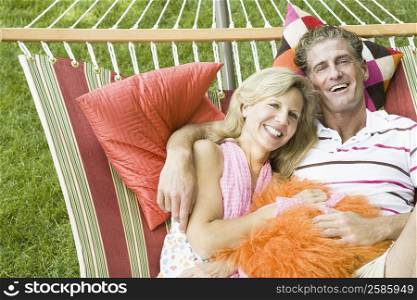 Portrait of a mature couple lying in a hammock and smiling