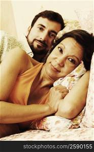 Portrait of a mature couple lying in bed