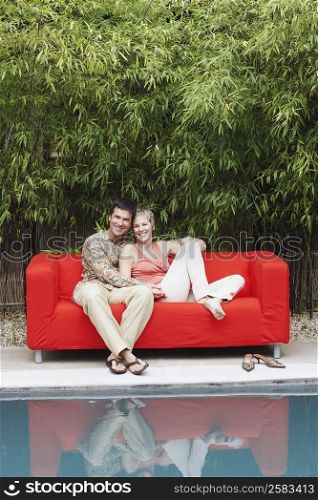 Portrait of a mature couple sitting on a couch and smiling