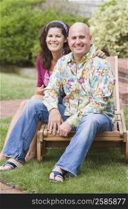 Portrait of a mature couple sitting on a lounge chair and smiling