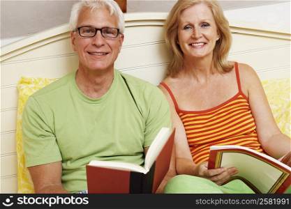 Portrait of a mature couple sitting on the bed and smiling