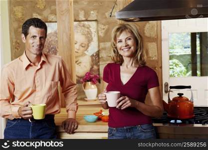 Portrait of a mature couple smiling and holding cups