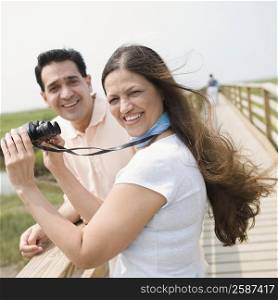 Portrait of a mature couple smiling on a bridge