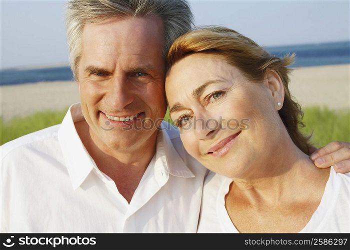 Portrait of a mature couple smiling on the beach
