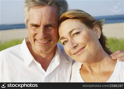 Portrait of a mature couple smiling on the beach