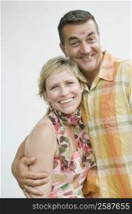 Portrait of a mature couple smiling with arm around