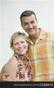 Portrait of a mature couple smiling with arm around