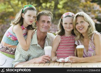 Portrait of a mature couple smiling with their two daughters