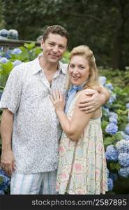 Portrait of a mature couple standing in a park and smiling