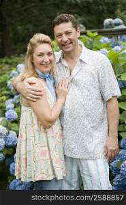 Portrait of a mature couple standing in a park and smiling