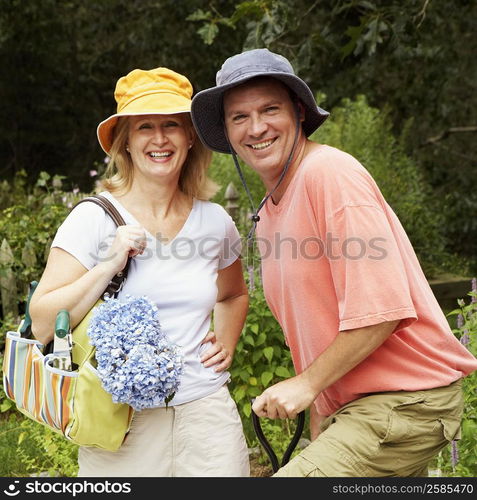 Portrait of a mature couple standing together in a garden and smiling