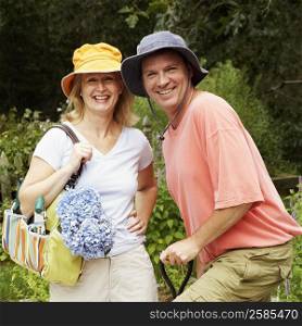 Portrait of a mature couple standing together in a garden and smiling