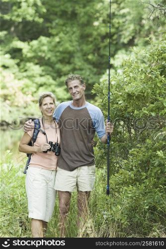 Portrait of a mature couple standing with their arm around in a forest