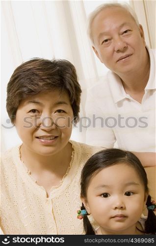 Portrait of a mature couple with their granddaughter