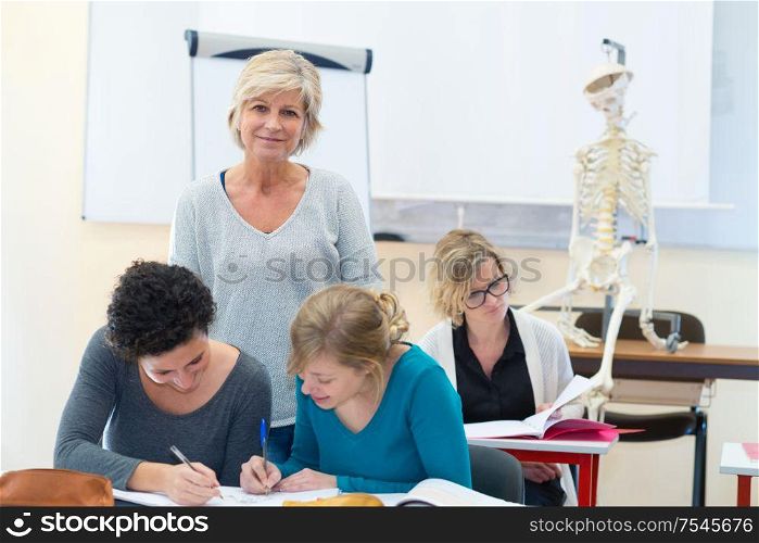 portrait of a mature female teacher in biology class