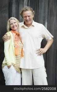 Portrait of a mature man and a mid adult woman standing together and smiling