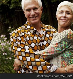 Portrait of a mature man and a senior woman smiling and embracing each other