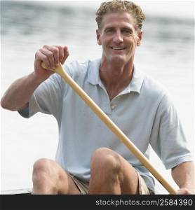 Portrait of a mature man canoeing in a river