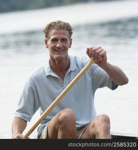 Portrait of a mature man canoeing in a river