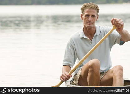 Portrait of a mature man canoeing in a river