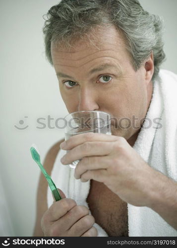 Portrait of a mature man drinking water