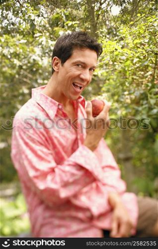 Portrait of a mature man eating an apple