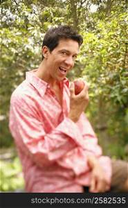 Portrait of a mature man eating an apple