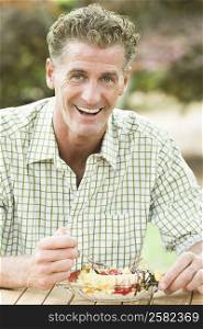 Portrait of a mature man eating an ice cream