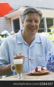 Portrait of a mature man eating fruit pie