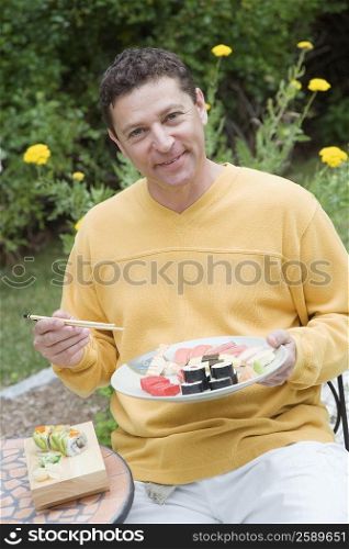 Portrait of a mature man eating sushi