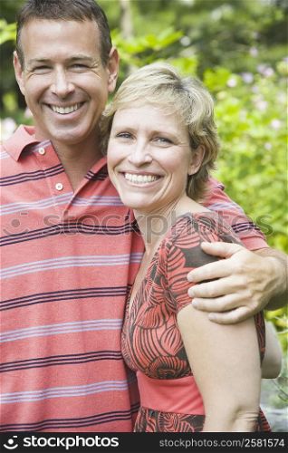 Portrait of a mature man embracing a mature woman and smiling