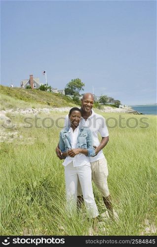 Portrait of a mature man embracing a mid adult woman